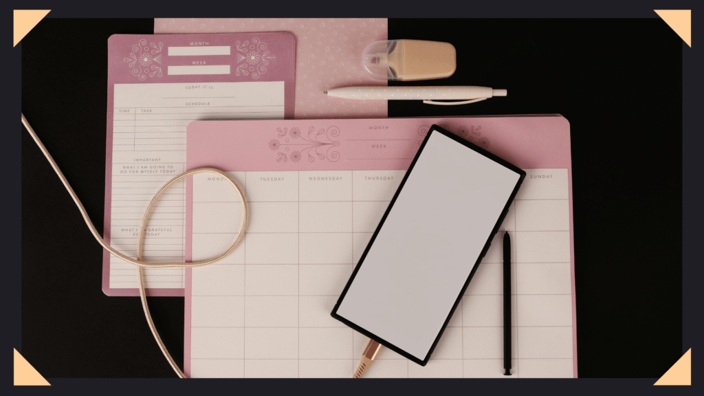 Image of calendar, smartphone, and planners